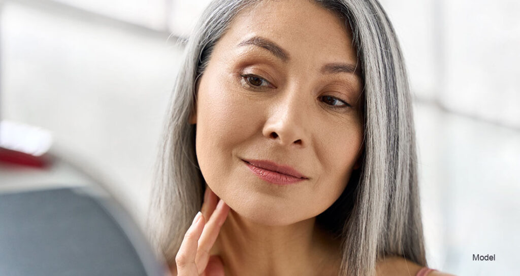 Mature woman looking at herself in the mirror