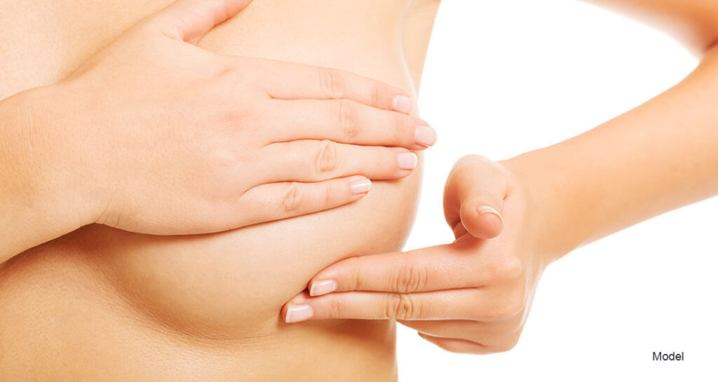 Woman touching her breast