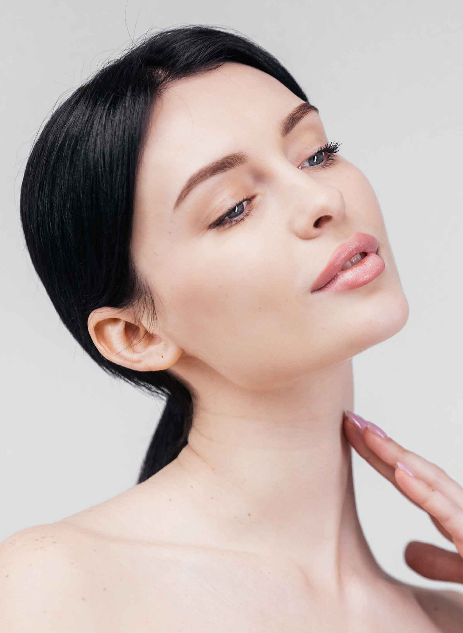 Woman touching her neck