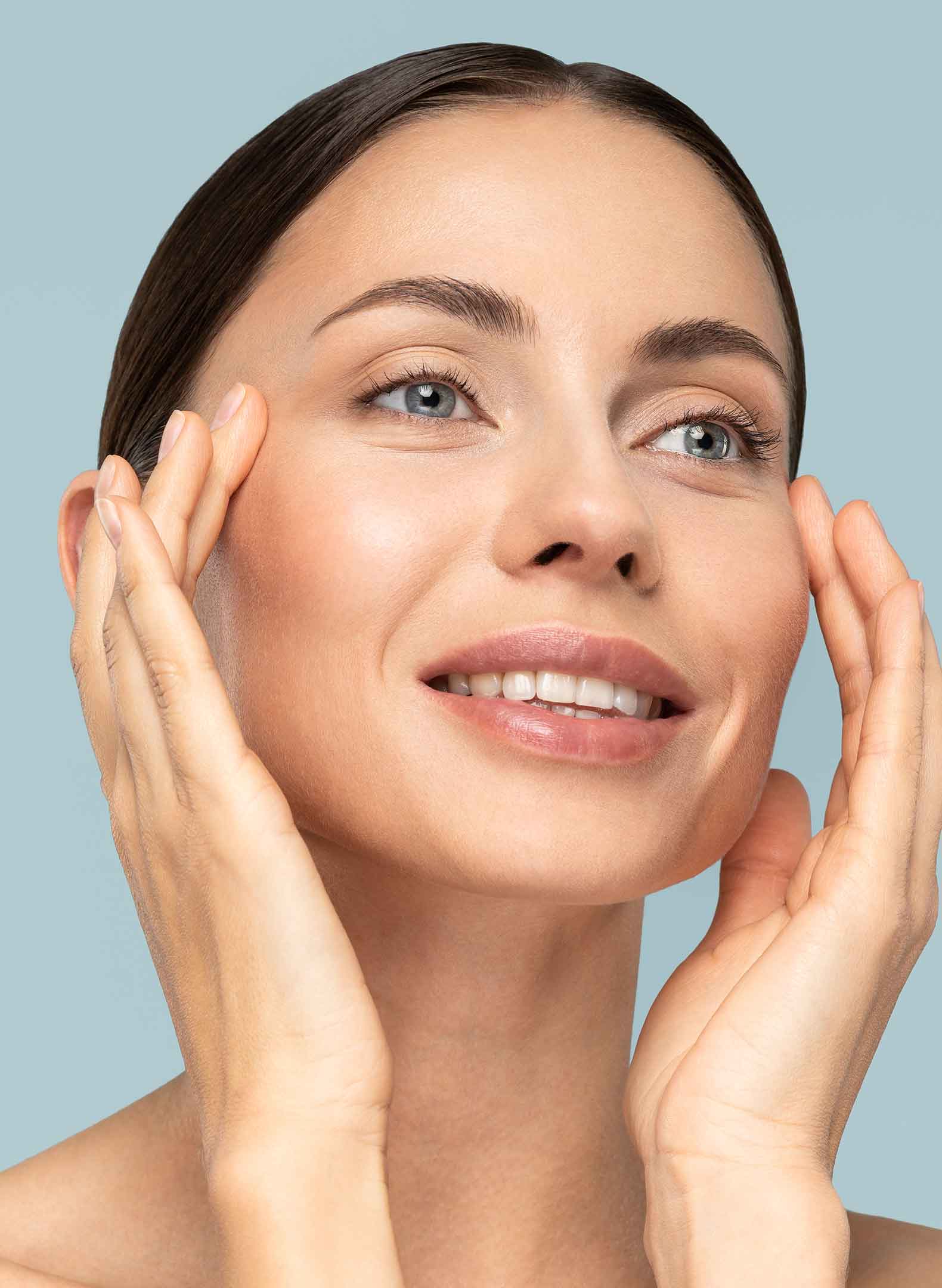 Smiling woman with her hands on her temples