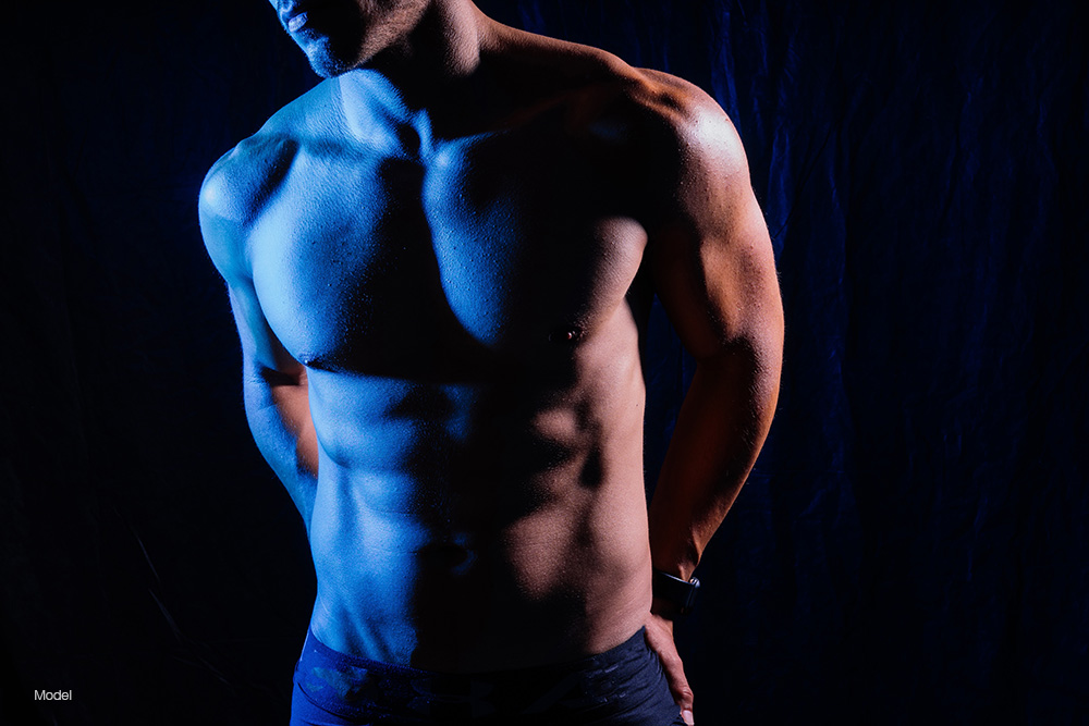 Fit man with his hands behind his back